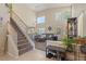 Open-concept living area with high ceilings, large windows and a staircase adjacent to the living room at 1906 Desert Sage Ave, North Las Vegas, NV 89031