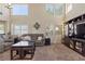 Cozy living room with high ceilings, plush seating, large windows, and modern entertainment center at 1906 Desert Sage Ave, North Las Vegas, NV 89031