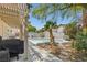 A view of the in-ground pool with seating areas at 1906 Desert Sage Ave, North Las Vegas, NV 89031