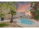 Inviting backyard pool with a desert landscape and relaxing lounge area, perfect for enjoying warm evenings at 1906 Desert Sage Ave, North Las Vegas, NV 89031