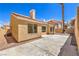 Backyard view featuring concrete patio, stucco wall, and desert landscaping at 2117 Desert Peak Rd, Las Vegas, NV 89134