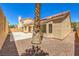 Backyard features desert landscaping, concrete patio, and stucco exterior walls at 2117 Desert Peak Rd, Las Vegas, NV 89134