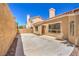 Exterior backyard featuring stucco wall, concrete patio, and landscaping at 2117 Desert Peak Rd, Las Vegas, NV 89134