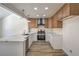 Well-lit kitchen features stainless steel appliances, stylish cabinets and light wood flooring throughout at 2117 Desert Peak Rd, Las Vegas, NV 89134