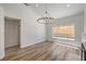 Sunlit living space with stylish chandelier lighting, wood flooring, and a bright, open feel at 2117 Desert Peak Rd, Las Vegas, NV 89134