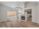 Inviting living room boasts a fireplace, contemporary light fixtures, and bright sunlight at 2117 Desert Peak Rd, Las Vegas, NV 89134