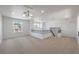 Expansive loft area featuring neutral carpet, large windows, and modern lighting at 2117 Desert Peak Rd, Las Vegas, NV 89134