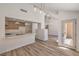 Open-concept kitchen and living area with modern lighting, seamlessly connecting the cooking and gathering spaces at 2117 Desert Peak Rd, Las Vegas, NV 89134