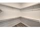 Organized walk-in closet featuring ample shelving and wood-look flooring at 2117 Desert Peak Rd, Las Vegas, NV 89134