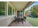 Relaxing covered back patio features custom brickwork, outdoor dining, and a well maintained lawn with playset at 2433 Amatrice St, Henderson, NV 89044