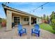 Spacious backyard featuring an extended patio, string lights, lawn, and a patio cover for outdoor enjoyment at 2433 Amatrice St, Henderson, NV 89044