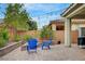 This backyard features paver patio with string lights, professional landscaping, and a retaining wall at 2433 Amatrice St, Henderson, NV 89044