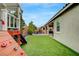 View of the backyard, highlighting the artificial turf, playhouse, and outdoor seating area for relaxation at 2433 Amatrice St, Henderson, NV 89044