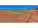 Well-maintained community baseball field with red clay, green grass, and a clear view of the surrounding area at 2433 Amatrice St, Henderson, NV 89044