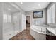 Bathroom featuring walk-in shower, soaking tub, tiled floors, and access to walk-in closet at 2433 Amatrice St, Henderson, NV 89044
