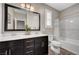 Bathroom showcasing a double sink vanity, a large mirror, and shower-over-tub setup at 2433 Amatrice St, Henderson, NV 89044