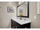 Bathroom featuring a double sink vanity with marble countertop and a large mirror at 2433 Amatrice St, Henderson, NV 89044