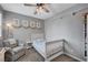 Cozy bedroom with a crib, comfortable chair, and artwork, designed for a peaceful retreat at 2433 Amatrice St, Henderson, NV 89044