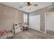 Cozy bedroom with a ceiling fan and a window with plantation shutters to let in natural light at 2433 Amatrice St, Henderson, NV 89044