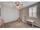 Cozy bedroom with a ceiling fan and a window with plantation shutters to let in natural light at 2433 Amatrice St, Henderson, NV 89044