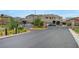 Gated community entrance boasts mature landscaping and attractive signage, enhancing curb appeal at 2433 Amatrice St, Henderson, NV 89044