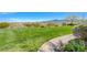 Expansive green lawn with a winding walkway and desert landscape, offering stunning views at 2433 Amatrice St, Henderson, NV 89044
