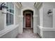 Close up of a home's entry, featuring a decorative front door, textured walls, and overhead lighting at 2433 Amatrice St, Henderson, NV 89044