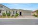 Charming single-story home featuring a two-car garage, desert landscaping, and a welcoming front porch at 2433 Amatrice St, Henderson, NV 89044