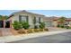 Single-story home with a two-car garage, desert landscaping, and a paved driveway at 2433 Amatrice St, Henderson, NV 89044