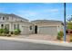 Street view of a charming single-story home with a two-car garage and desert landscaping at 2433 Amatrice St, Henderson, NV 89044
