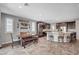 Bright kitchen and dining area features a dining table set, an island with bar stools, and dark cabinets at 2433 Amatrice St, Henderson, NV 89044