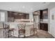 Gourmet kitchen featuring dark cabinets, stainless appliances, a large island with bar seating at 2433 Amatrice St, Henderson, NV 89044