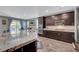 Kitchen with a granite counter island, stainless appliances and dark cabinetry at 2433 Amatrice St, Henderson, NV 89044