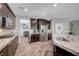 Modern kitchen with granite countertops, stainless steel appliances and dark wood cabinets at 2433 Amatrice St, Henderson, NV 89044