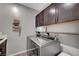 Convenient laundry room equipped with overhead cabinetry and stainless steel washer and dryer at 2433 Amatrice St, Henderson, NV 89044