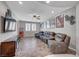 Living room features a ceiling fan, TV, decor and furniture at 2433 Amatrice St, Henderson, NV 89044