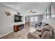 The living room is complete with furniture, a ceiling fan and a television at 2433 Amatrice St, Henderson, NV 89044