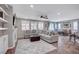 Open-concept living room with comfortable seating, a ceiling fan, and lots of natural light at 2433 Amatrice St, Henderson, NV 89044