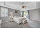 Well-lit main bedroom with ceiling fan, backyard views, ensuite access, and neutral decor at 2433 Amatrice St, Henderson, NV 89044
