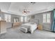 Spacious main bedroom featuring plush carpet, tray ceilings, shuttered windows, and designer touches at 2433 Amatrice St, Henderson, NV 89044