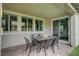 Covered patio featuring an outdoor dining set and views of the lush backyard, ideal for entertaining at 2433 Amatrice St, Henderson, NV 89044