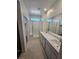 Bathroom featuring a double vanity, walk-in shower with glass door, and modern fixtures at 289 Aravalli Crest St, Henderson, NV 89015