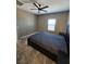 Carpeted bedroom featuring a ceiling fan and window at 289 Aravalli Crest St, Henderson, NV 89015