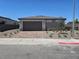 Charming single-story home featuring a two-car garage, tidy landscaping, and a well-maintained exterior at 289 Aravalli Crest St, Henderson, NV 89015