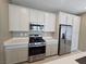View of kitchen with stainless steel appliances, quartz countertops, and tile floors at 289 Aravalli Crest St, Henderson, NV 89015
