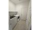 Bright laundry room with tile floors, modern washer, and dryer at 289 Aravalli Crest St, Henderson, NV 89015