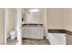 Bathroom featuring double sinks, a bathtub, and an enclosed toilet at 3064 Bicentennial Pkwy, Henderson, NV 89044