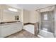 Bathroom showcasing double sinks, a bathtub, and glass-enclosed shower at 3064 Bicentennial Pkwy, Henderson, NV 89044