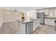 Kitchen island boasts stainless steel dishwasher, double sink, and seating space overlooking the living area at 3064 Bicentennial Pkwy, Henderson, NV 89044
