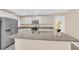 Bright kitchen features stainless steel appliances, granite countertops, and ample white cabinetry at 3064 Bicentennial Pkwy, Henderson, NV 89044